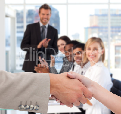 Businessman and woman shaking hands