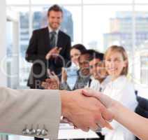 Businessman and woman shaking hands