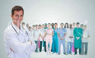 Smiling doctor in front of a team of doctors standing together