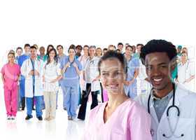 Smiling doctors in front of a team of doctors standing together