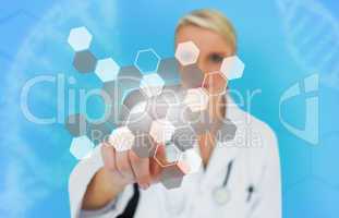 Blonde doctor pressing touchscreen displaying chemical formula