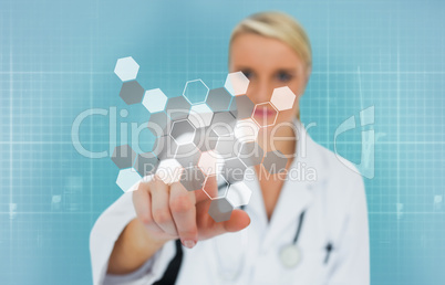Blonde doctor using touchscreen displaying chemical formula