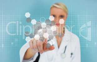 Blonde doctor using touchscreen displaying chemical formula
