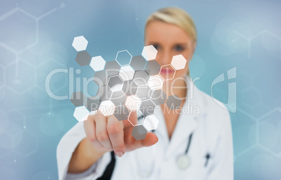 Blonde doctor pressing touchscreen displaying chemical formula