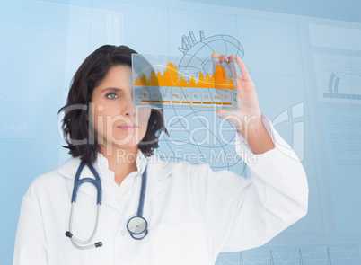 Brunette doctor looking at a graph with futuristic technology