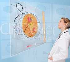 Thoughtful doctor using an interface for brain analysis