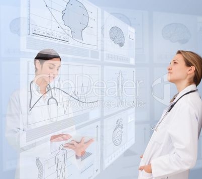 Women doctors using futuristic interfaces