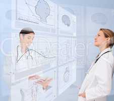 Women doctors using futuristic interfaces