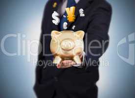Businessman holding a gold piggy bank