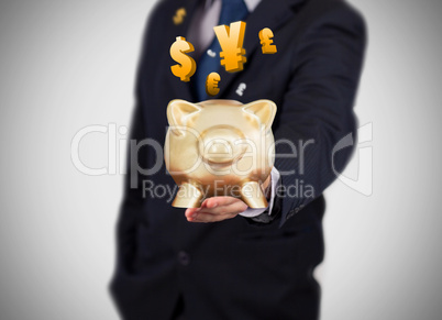 Businessman showing a gold piggy bank