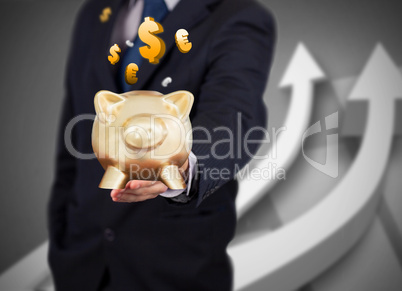 Businessman holding a gold piggy bank with currencies