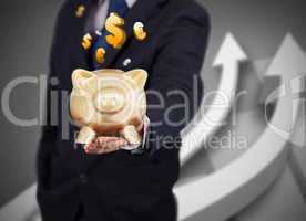 Businessman holding a gold piggy bank with currencies