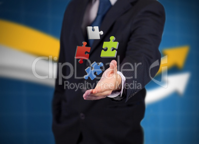 Businessman with digital coloured puzzles
