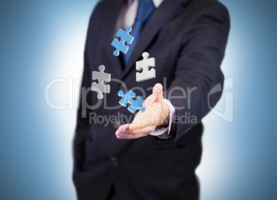 Businessman with digital white and blue puzzles