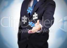 Businessman with digital puzzles levitating