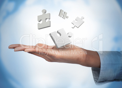 Hand with digital white puzzles