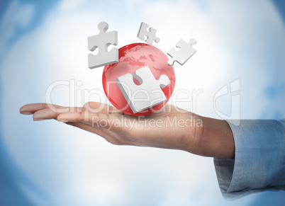 Hand with digital white puzzles and a red globe