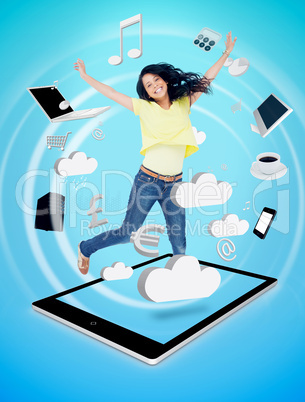 Smiling woman jumping on a tablet pc Smiling woman jumping on a tablet pc