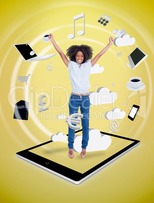 Happy woman jumping on a tablet pc