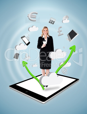 Smiling businesswoman holding a coffee on a tablet pc