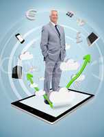 Smiling businessman standing on a tablet pc