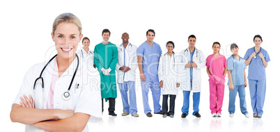 Smiling doctor standing in front of her medical team in line