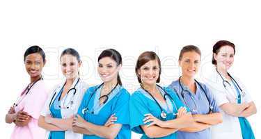 Smiling female hospital workers standing arms folded in line