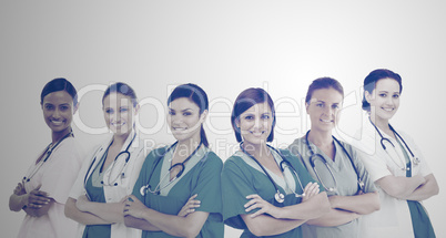 Female hospital workers standing arms folded in line