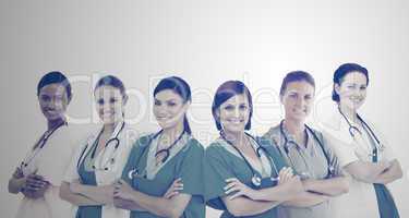 Female hospital workers standing arms folded in line