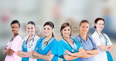 Female hospital workers standing arms folded