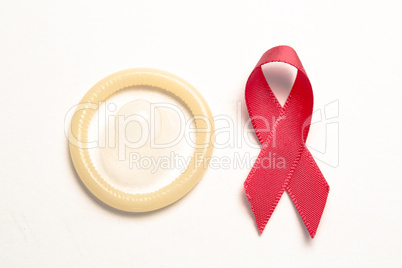 Red awareness ribbon and condom