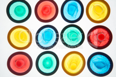 Twelve colourful condoms