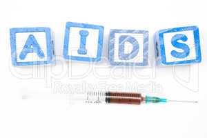 Wood blocks spelling out aids with syringe