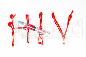 HIV spelled out in blood and syringe filled with blood