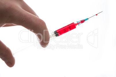Hand holding syringe of blood