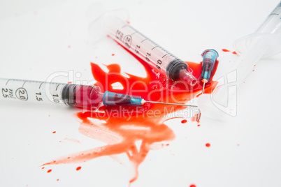 Three broken needles in pool of blood