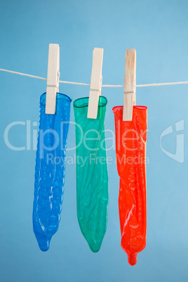 Three condoms hanging on line