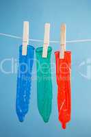 Three condoms hanging on line
