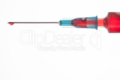 Drop of blood on end of syringe