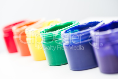 Rainbow paint pots in a line for gay pride