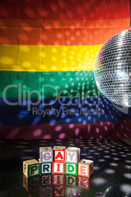 Blocks spelling out gay pride under light of disco ball