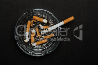 Burning cigarette left in ashtray