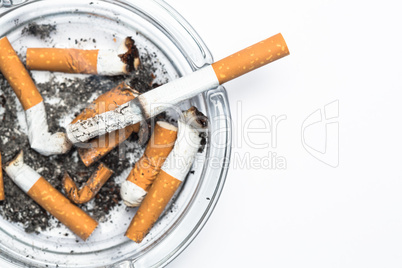 Overhead of burning cigarette in ashtray with copy space