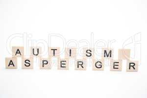 Autism and asperger spelled out in plastic letter pieces