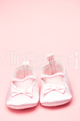 Baby girls pink booties with copy space