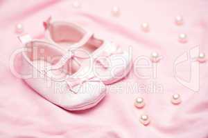 Baby girls pink booties on pink blanket