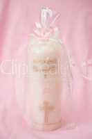 Christening candle wrapped up for a girl