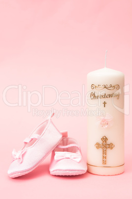 Christening candle with pink baby booties