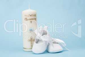 Christening candle for a boy with white baby booties