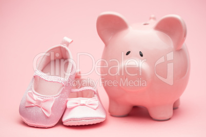 Pink booties and piggy bank